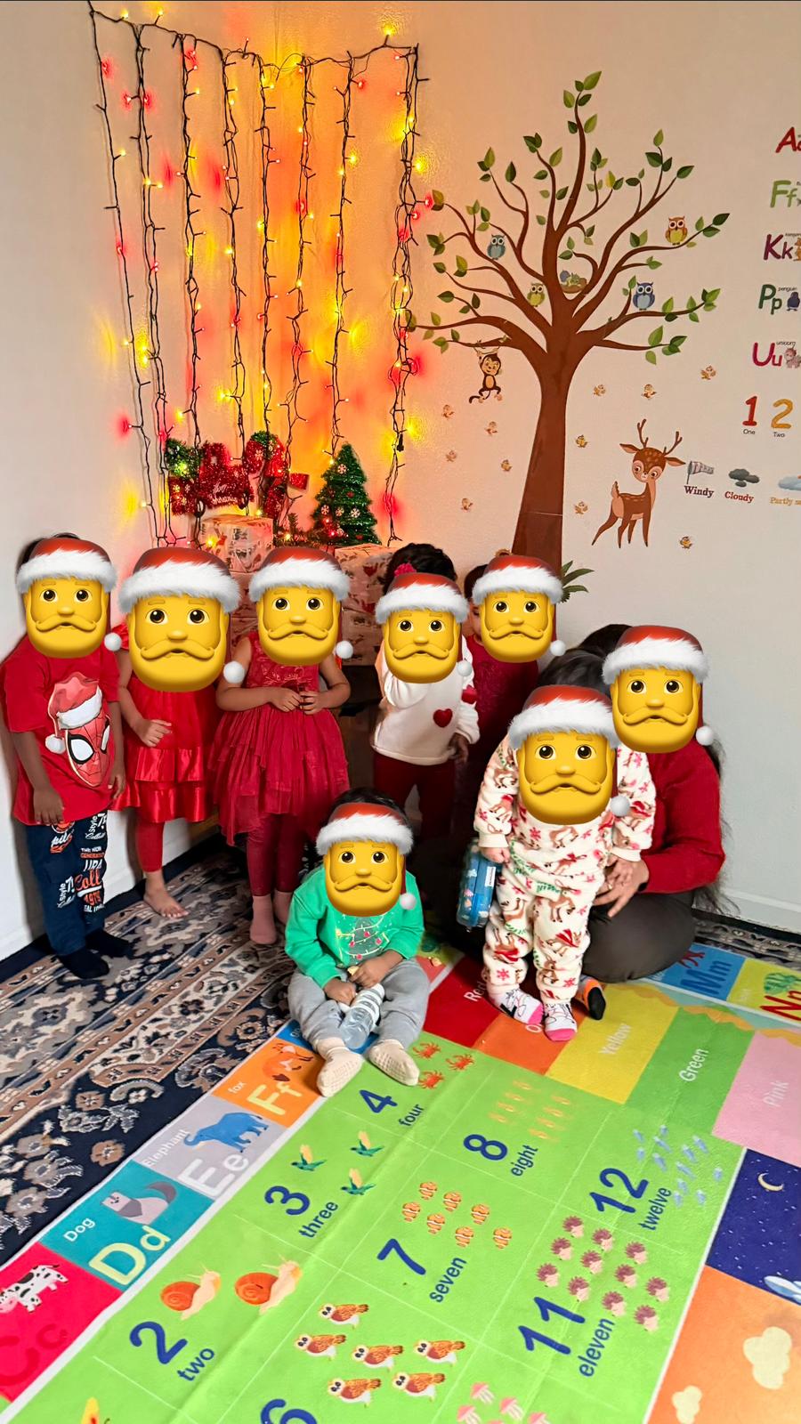 Children sitting on a colorful learning mat near holiday decorations
